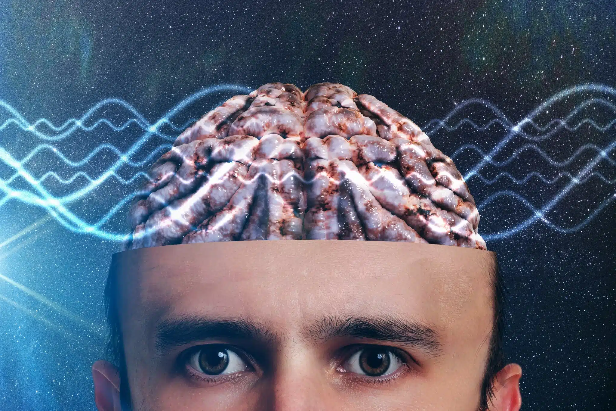 Cerebro humano con ondas neuronales sobre un fondo cósmico, representando el misterio de la conciencia.